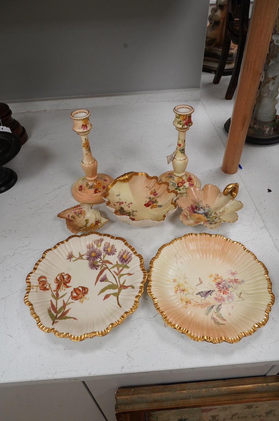 A pair of Royal Worcester blush ivory candlesticks, three bon bon dishes and a pair of plates, tallest 20cm. Condition - mostly good, some damage